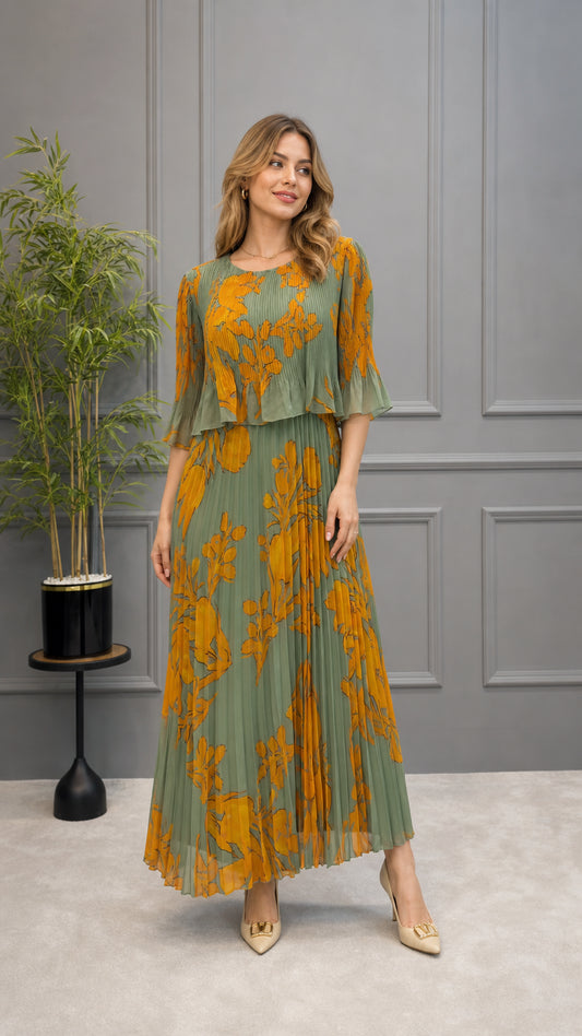 Front full-length view of model wearing sage green pleated floral maxi dress with layered ruffle bodice