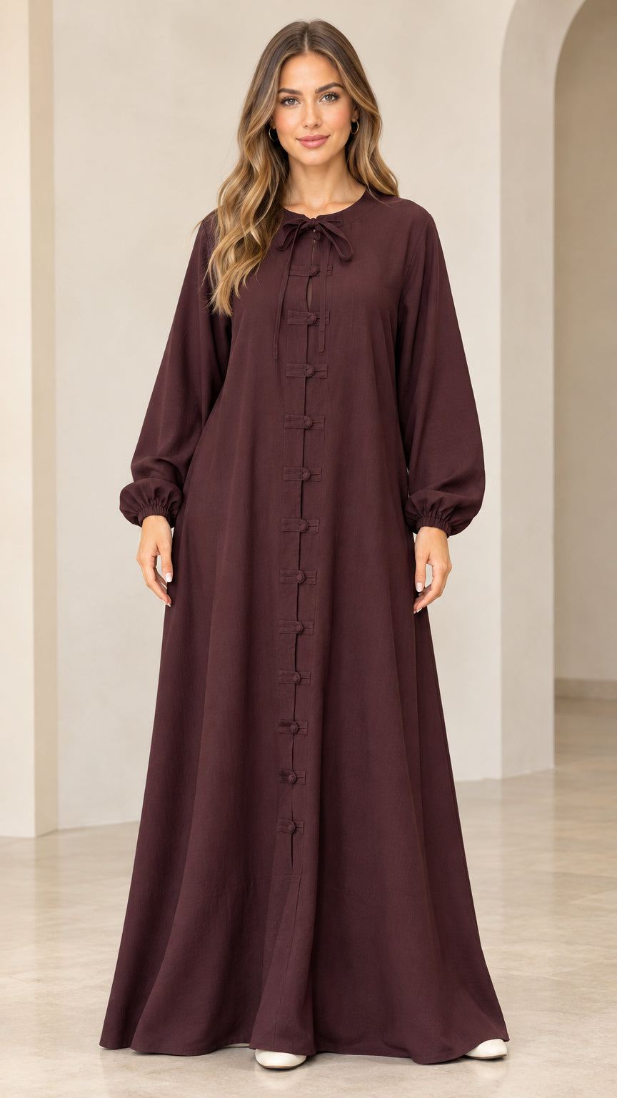 Burgundy long sleeve maxi dress with tie neck and frog buttons front view