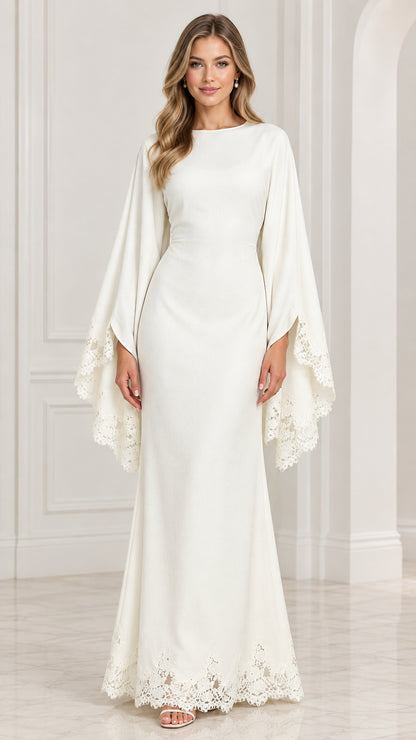 Front view of model wearing white boat neck maxi gown with lace trim cape sleeves