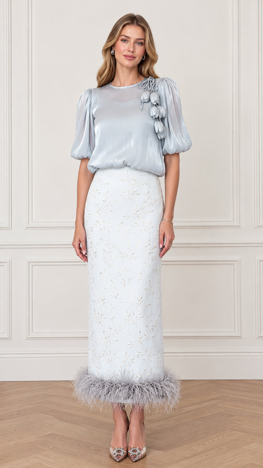 Model wearing an Ice Blue puff sleeve top and feather trim embroidered column maxi skirt set from front view