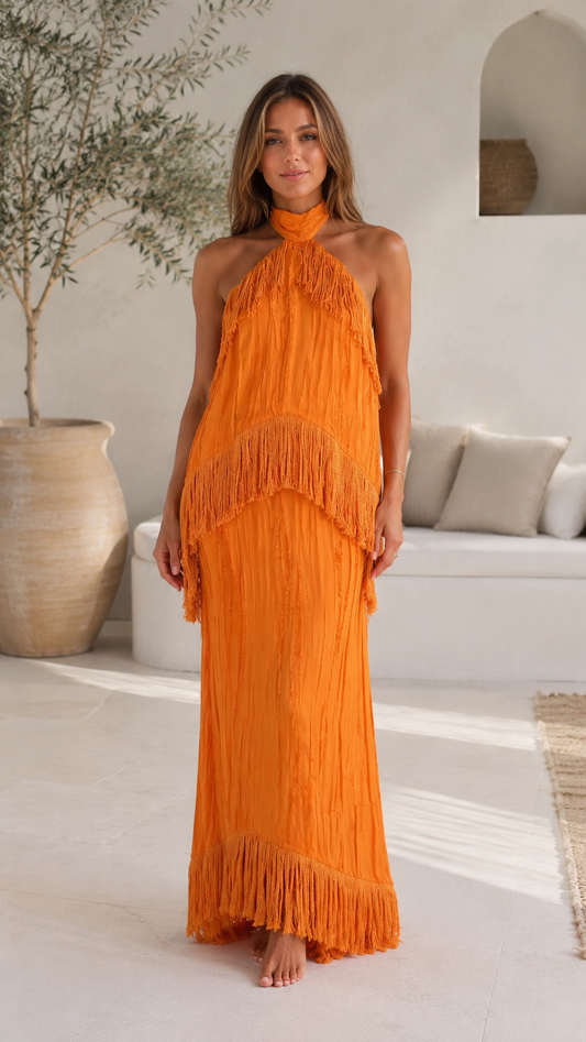 Front view of orange halter backless fringe maxi dress with layered fringe overlay
