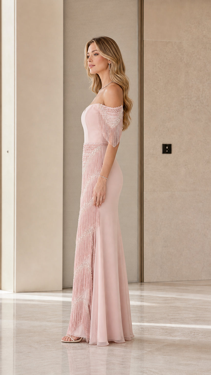 Side profile view of dusty rose evening dress highlighting fringe skirt and sleeve details