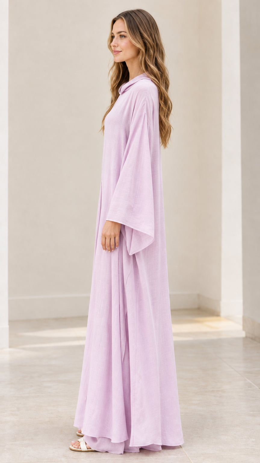 Side profile of model in lavender long-sleeve loose-fitting maxi gown