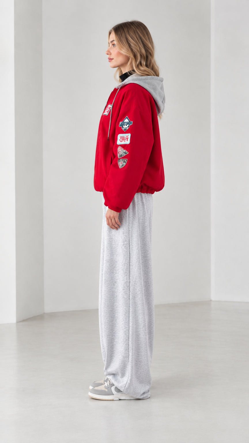 Side profile view of red patch hooded bomber jacket with contrast grey hood