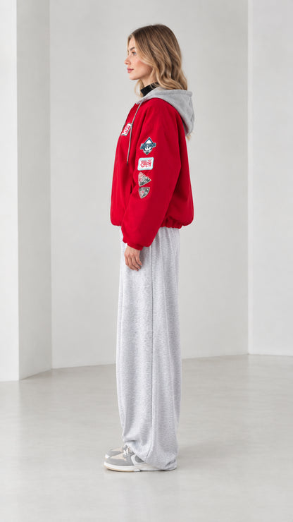 Side profile view of red patch hooded bomber jacket with contrast grey hood