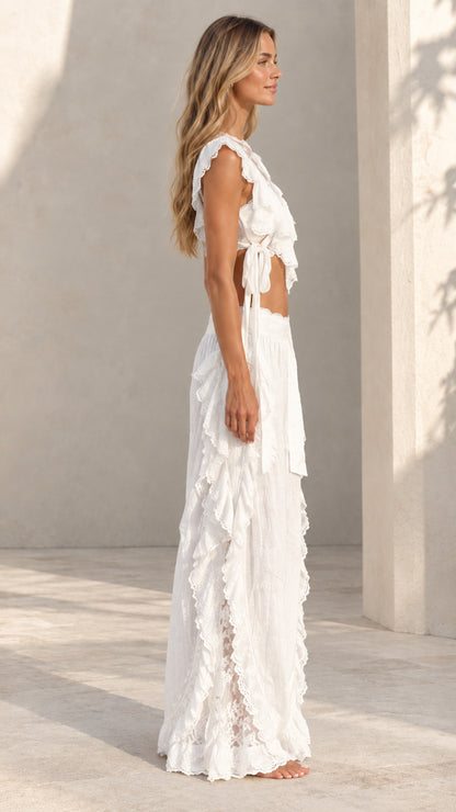 Side view of woman wearing white lace-accented two-piece matching set