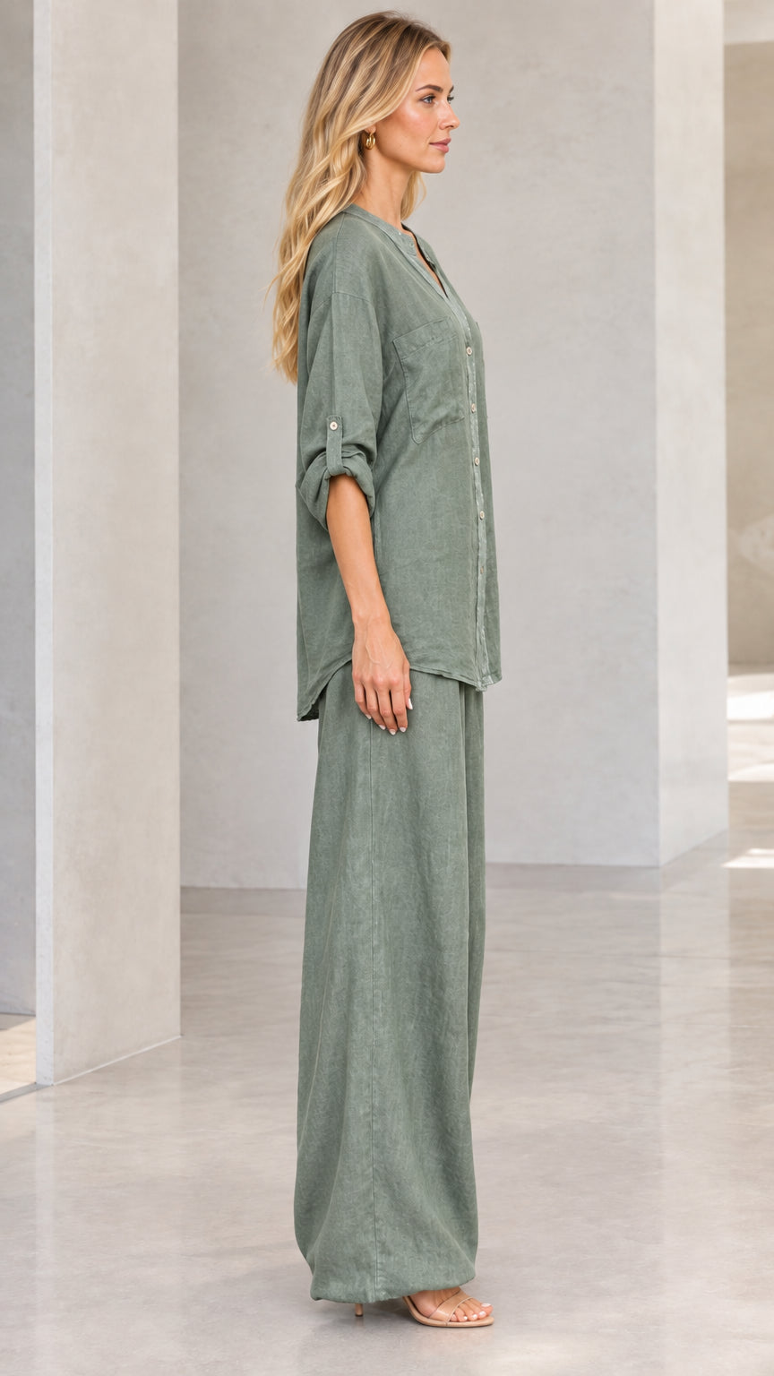 Side profile of woman wearing sage green matching button-down and wide-leg trousers