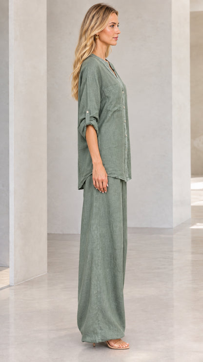 Side profile of woman wearing sage green matching button-down and wide-leg trousers