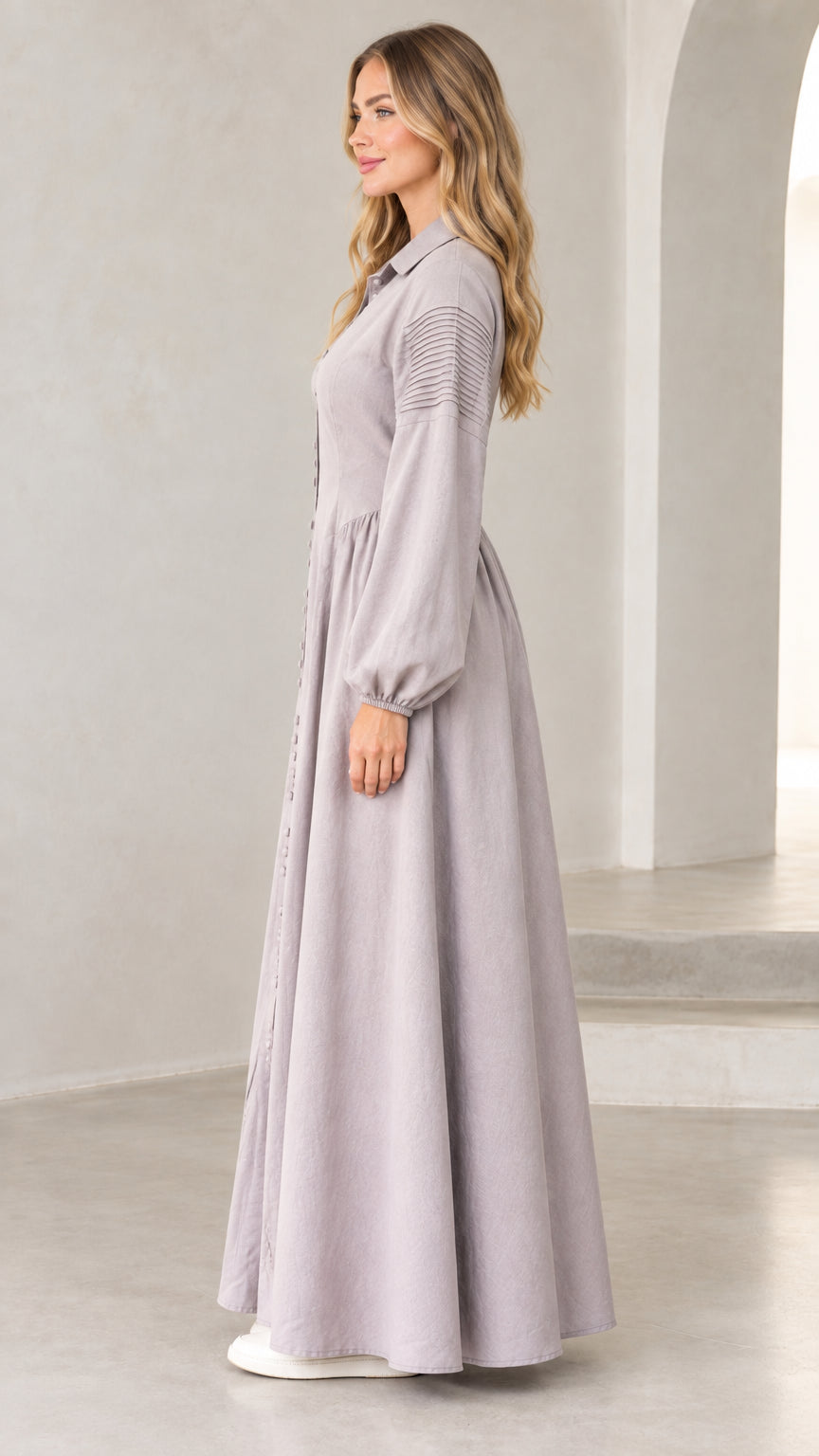 Side profile of woman in lavender grey long sleeve button-down maxi dress