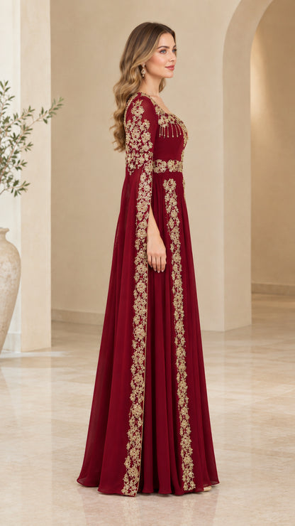 Side angle view of model wearing burgundy embroidered cape maxi dress