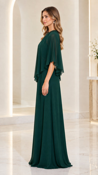 Side profile of dark green capelet evening gown showing flowing drape