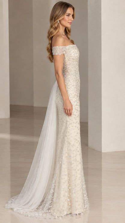 Side profile view of ivory beaded formal gown showing attached side tulle overskirt