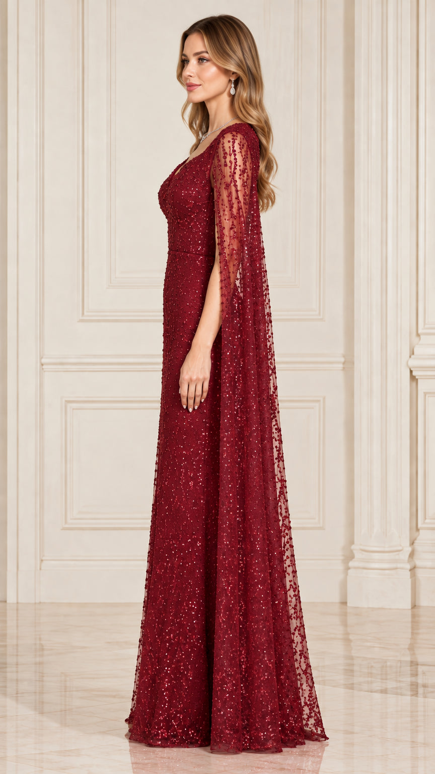 Side profile of burgundy sequin cape evening gown showing drape