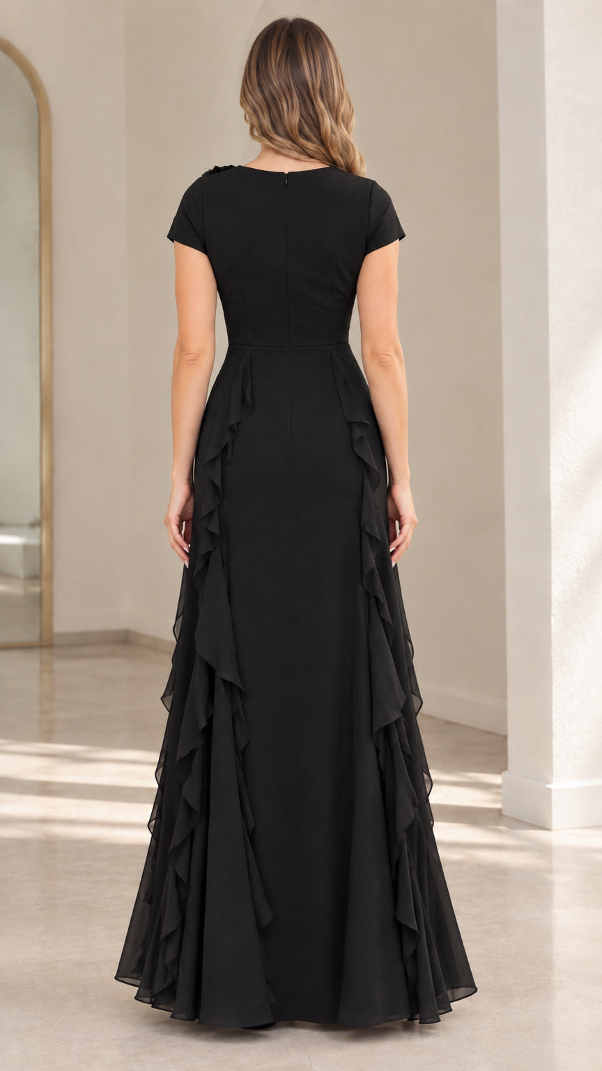 Back view of black floor length evening dress featuring clean tailored fit and cascading ruffles