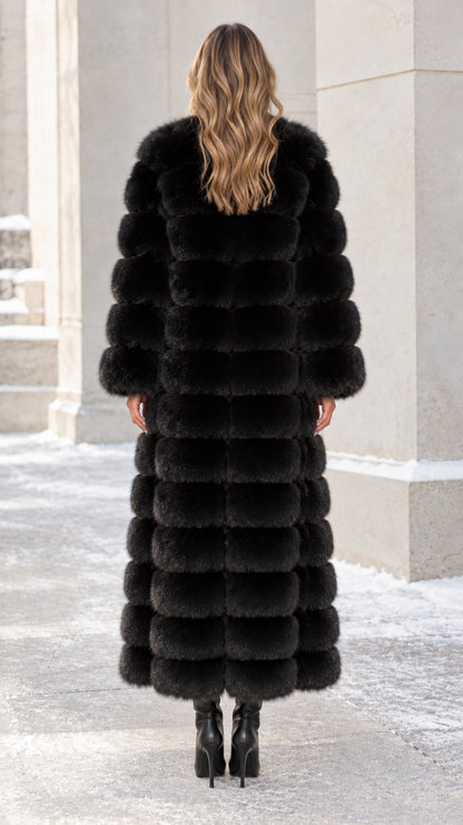 Back view of model in full-length black paneled faux fur winter coat