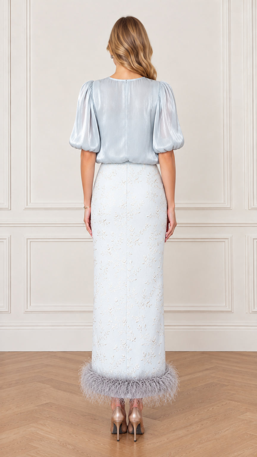 Back view of model in Ice Blue satin puff sleeve blouse and column maxi skirt