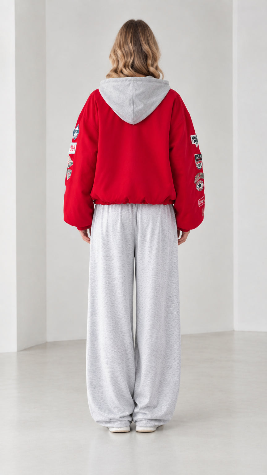 Back view of woman wearing red hooded jacket with grey hood
