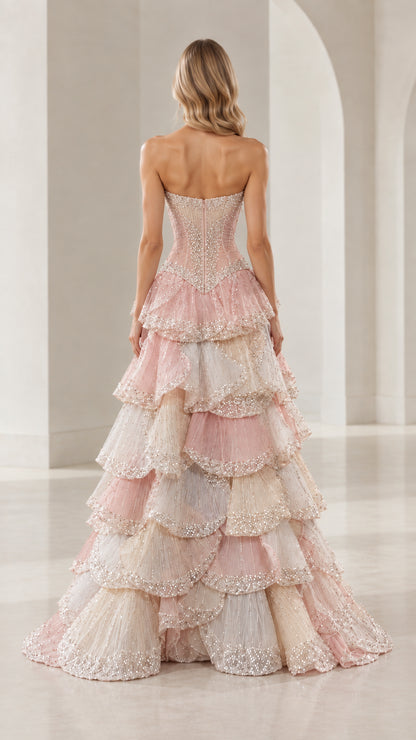Back view of model wearing Blush Pink Multi strapless evening gown with cascading ruffles