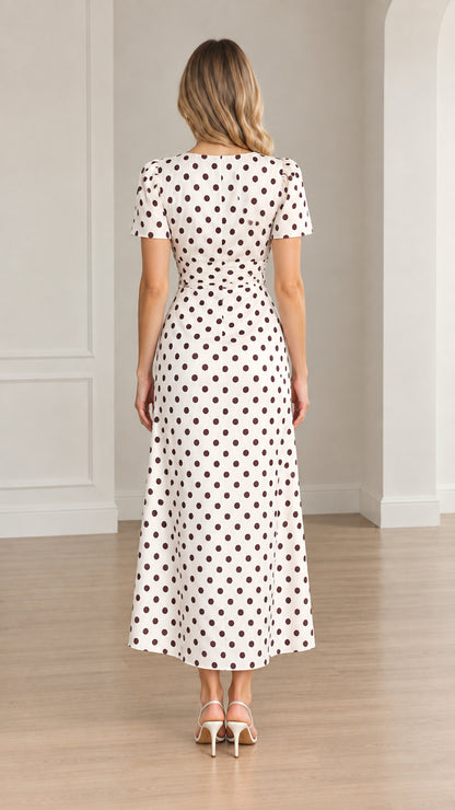 Back view of woman wearing white polka dot short sleeve midi dress