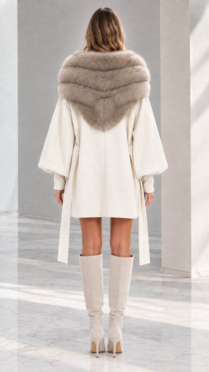 Back view of woman wearing Cream cape coat showing wide faux fur collar and lantern sleeves
