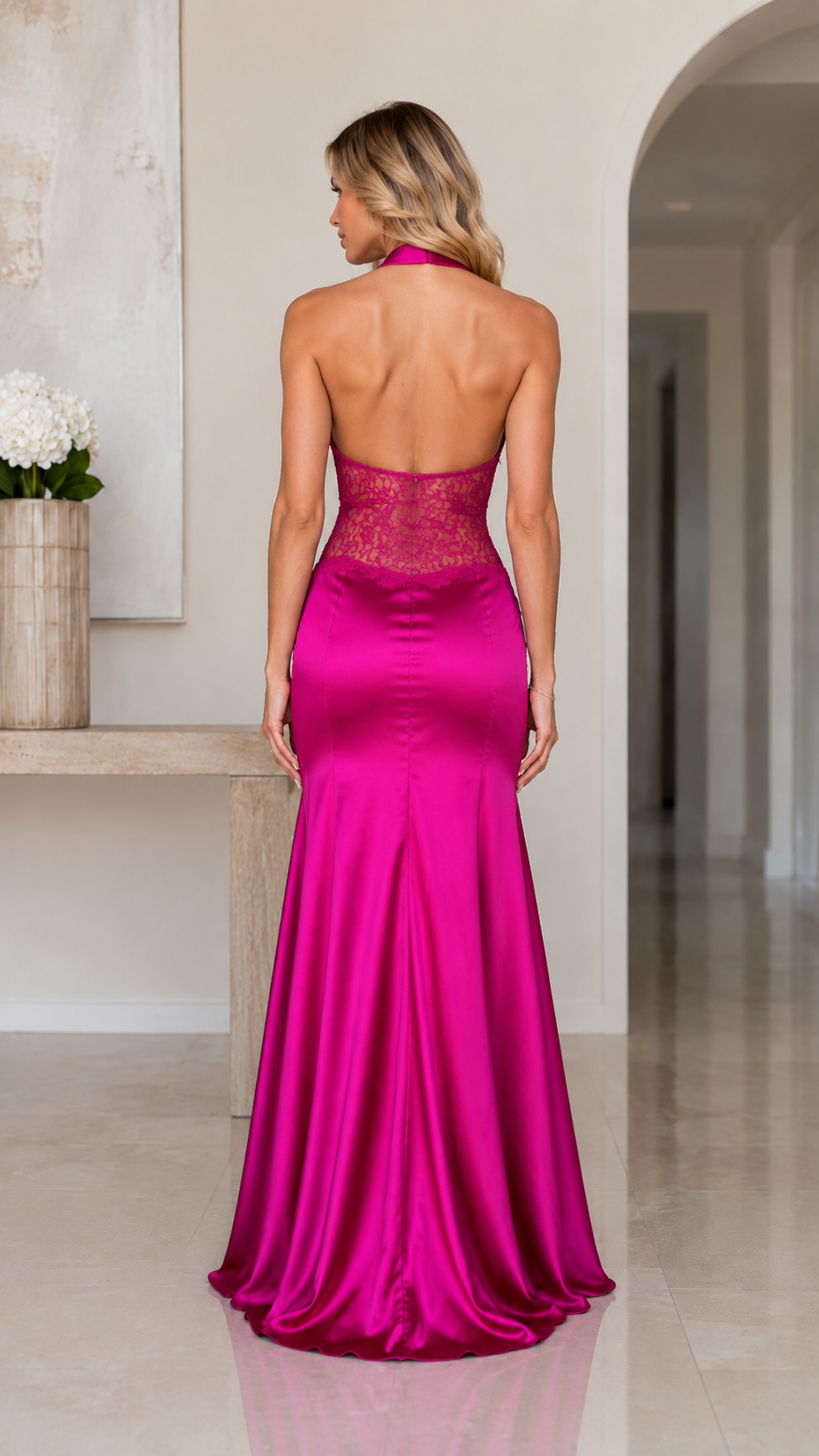 Back view of fuchsia open-back mermaid evening dress with floor-length satin-look skirt