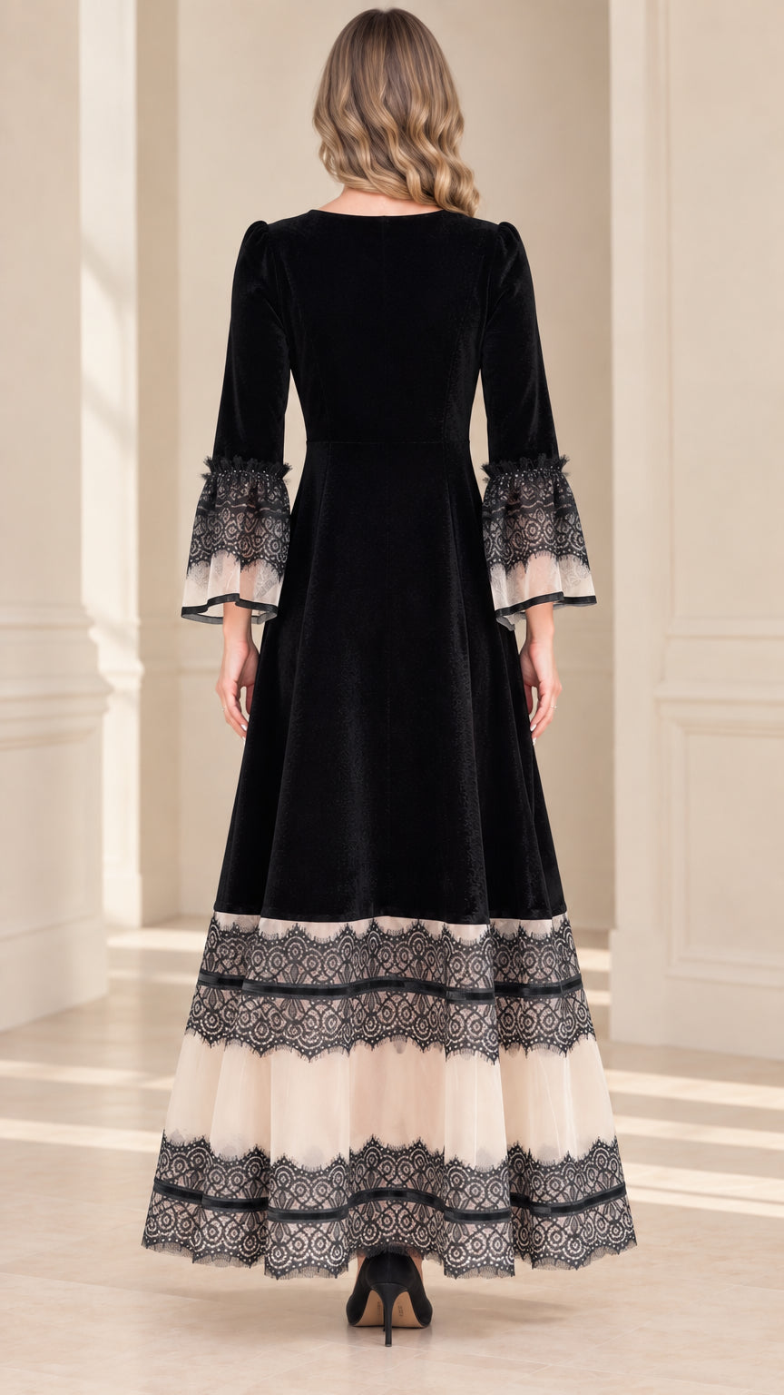 Back view of black velvet evening gown showing full-length silhouette and tiered lace bottom