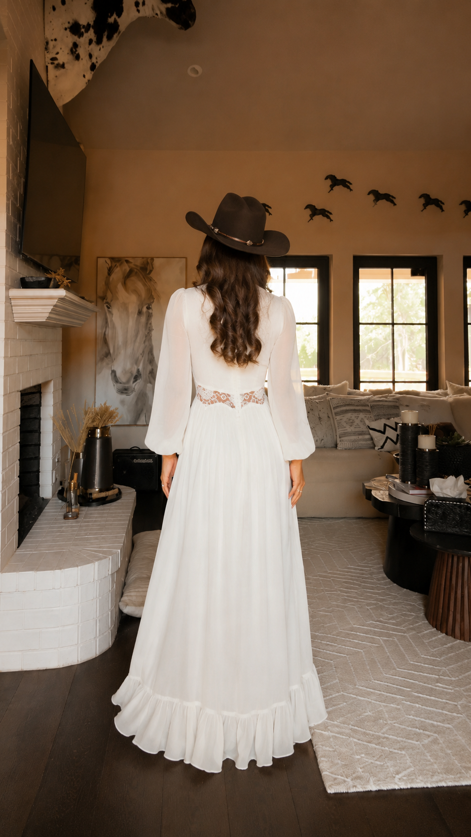 Back view of ivory maxi dress with long sleeves, lace-look back waist detail and full flowing skirt