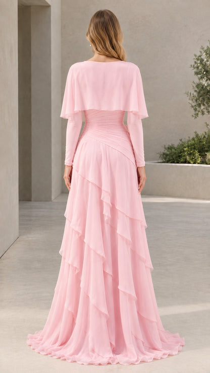 Back view of woman in Light Pink tiered ruffle chiffon maxi dress with capelet