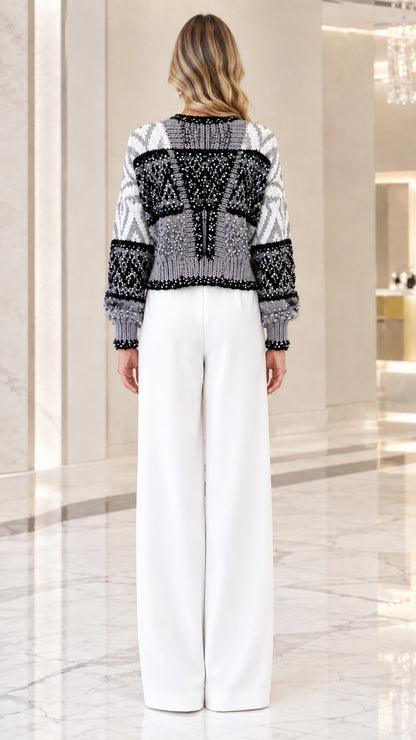 Back view of model showing geometric pattern on gray sequin knit sweater