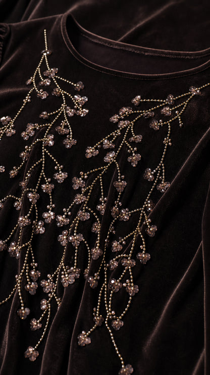 Close-up detail of the intricate floral branch beadwork on the velvet top