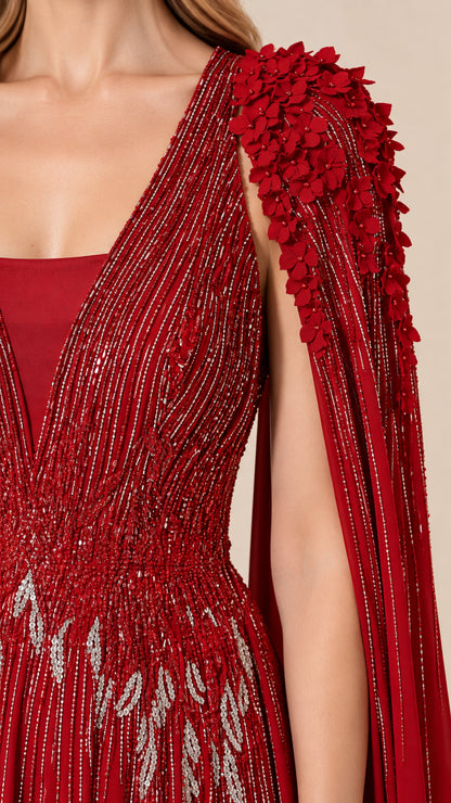 Close-up detail of intricate red linear beadwork and 3D petal floral shoulder accents