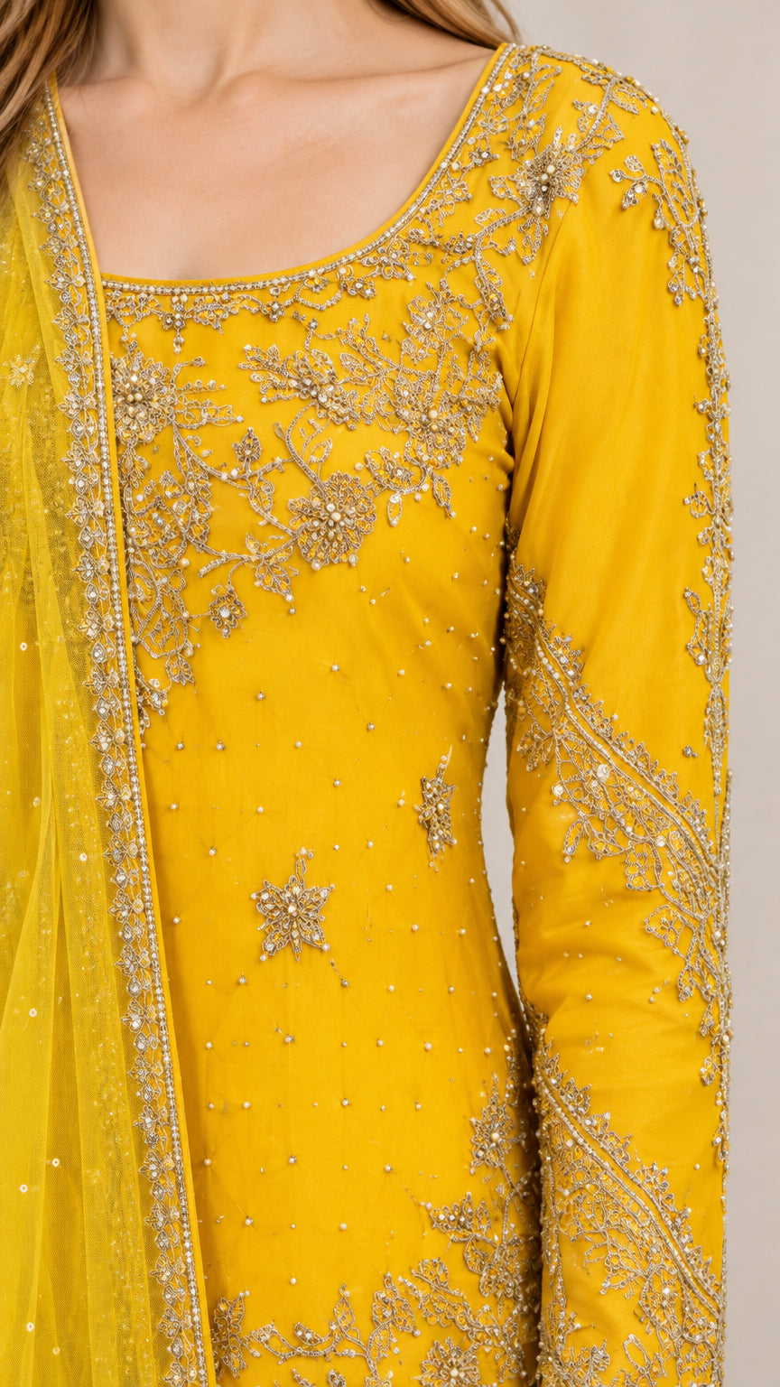 Close-up detail of intricate gold-tone embroidery on the Mustard Yellow neckline and sleeve