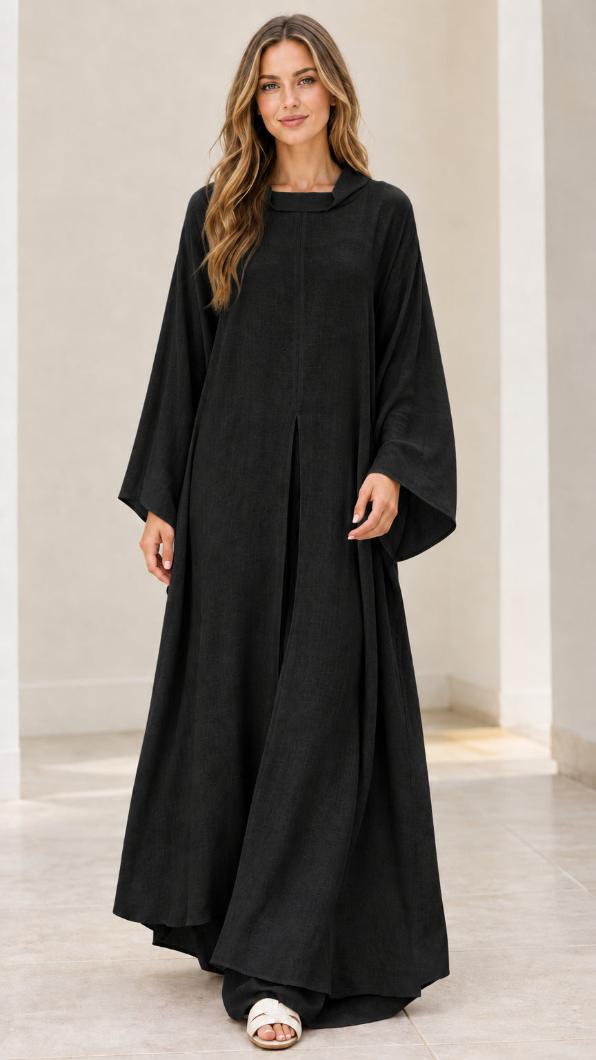 Front full view of model wearing black long-sleeve maxi kaftan dress