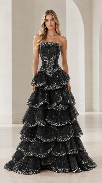 Front view of black strapless tiered ruffle evening gown with sequin details
