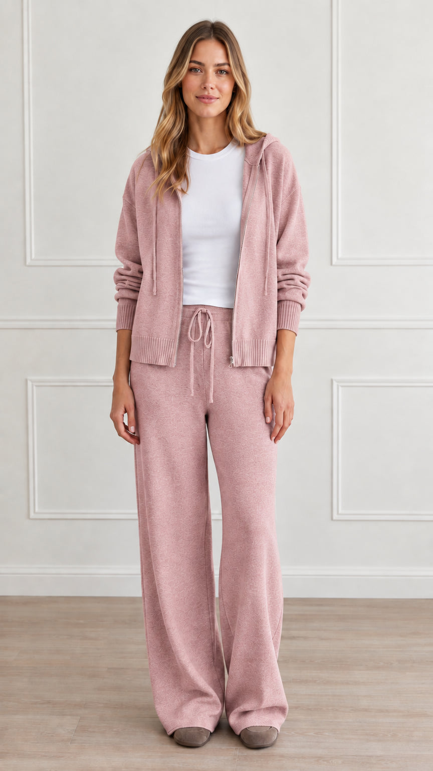Front view of model wearing dusty pink knit zip-up hoodie and matching wide-leg lounge pants