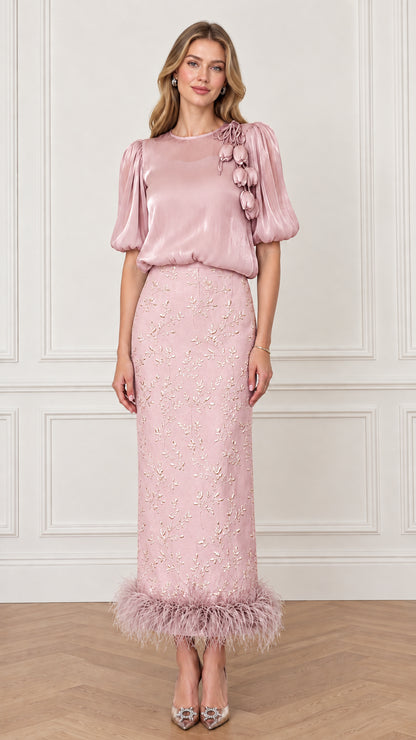Model wearing Blush Pink puff sleeve evening top and embroidered feather hem maxi skirt