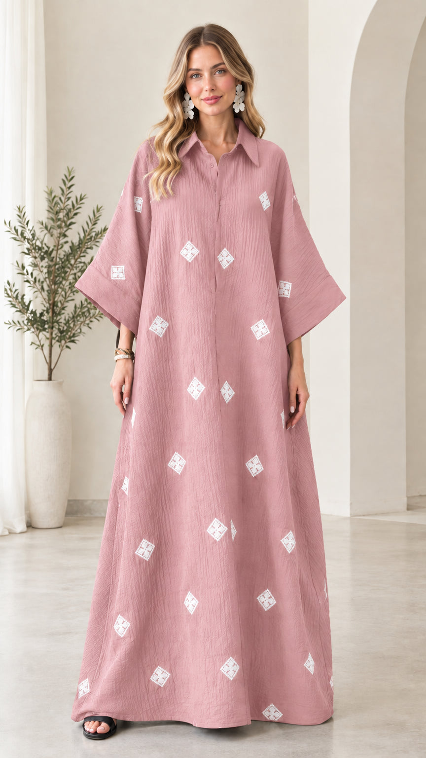 Front view of model wearing dusty pink embroidered crinkle maxi shirt dress