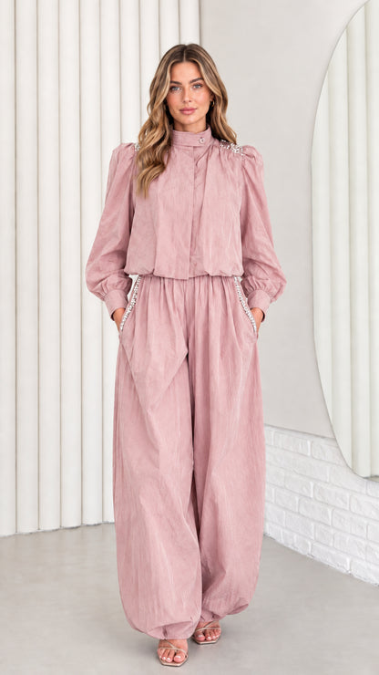 Front view of model wearing dusty pink rhinestone balloon leg jumpsuit