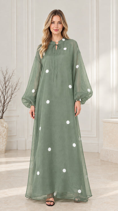 Front view of sage green polka dot flowy maxi dress