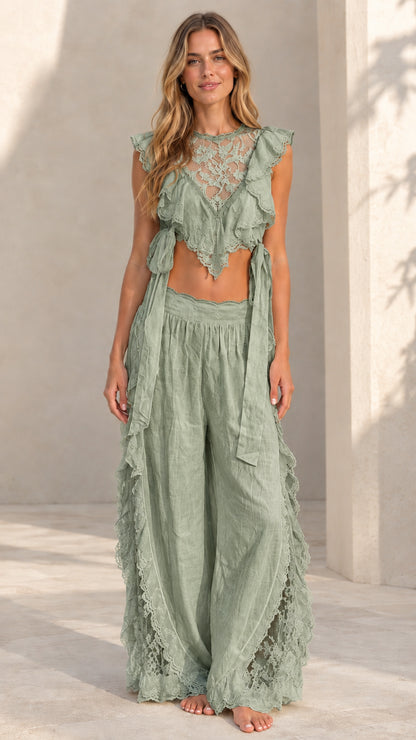 Woman wearing sage green lace ruffle crop top and matching wide-leg palazzo pants