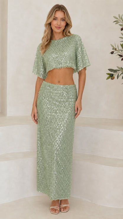 Front full-length view of woman wearing sage green sequin two-piece crop top and maxi skirt set