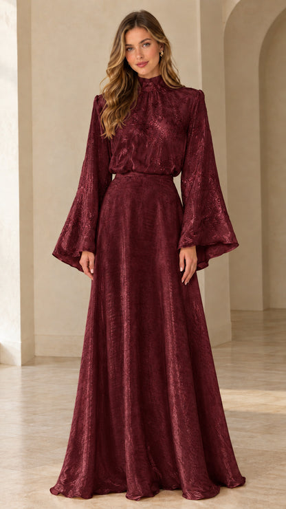 Front full view of woman wearing burgundy wine red high neck bell sleeve evening gown