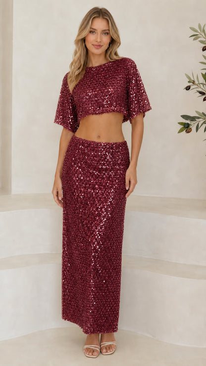 Front full-length view of woman wearing burgundy sequin two-piece crop top and maxi skirt set