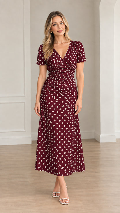 Front view of woman wearing burgundy polka dot short sleeve midi dress