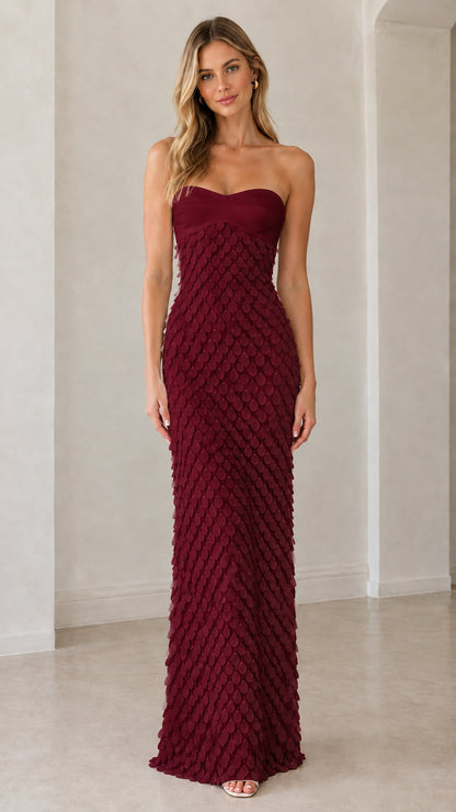 Front view of model wearing burgundy strapless petal textured formal gown