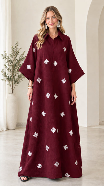 Front view of model wearing burgundy red embroidered crinkle maxi shirt dress