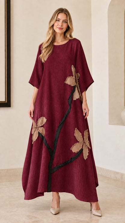 Woman wearing burgundy wine red floral appliqué maxi dress