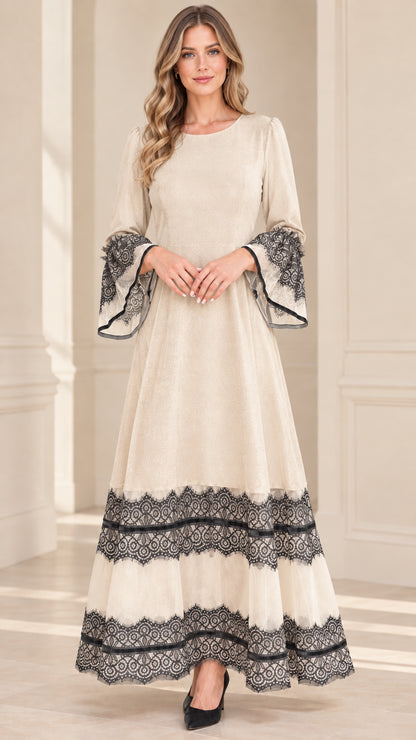 Model wearing champagne cream velvet maxi dress with contrast black lace trim