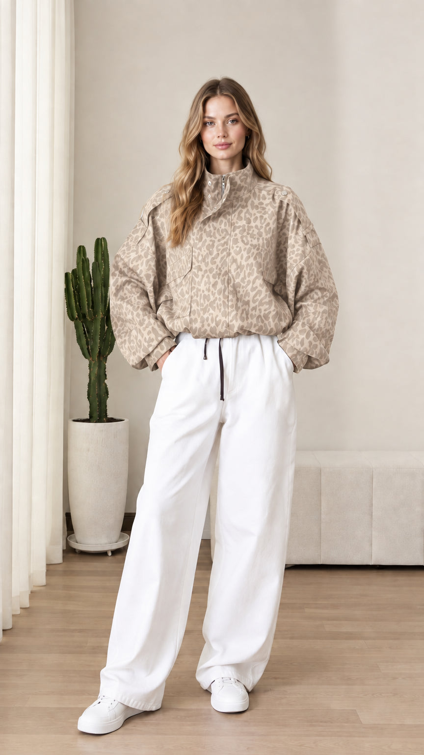 Front view of model wearing beige tan leopard print windbreaker pullover jacket