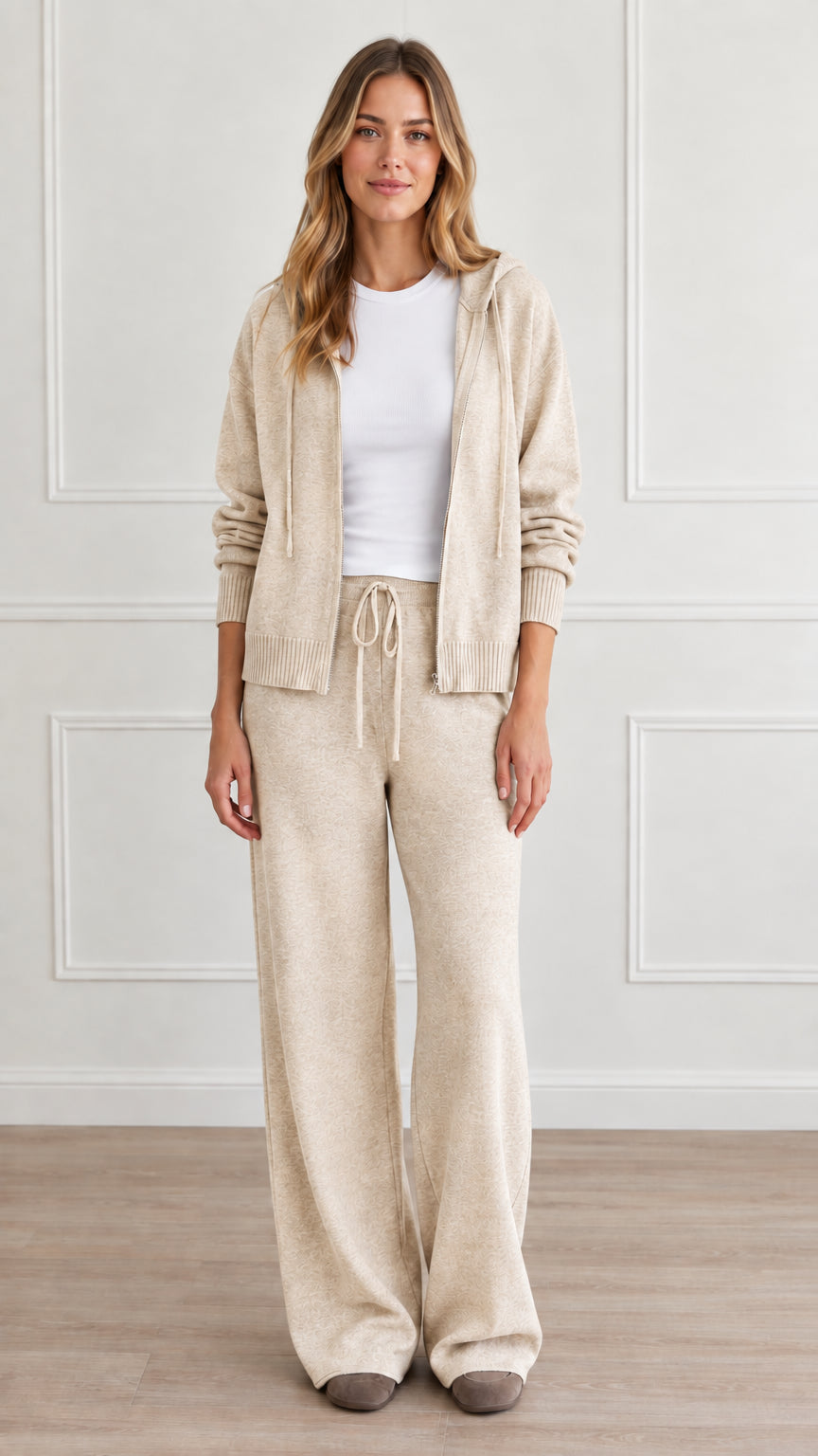 Front view of model wearing cream beige knit zip-up hoodie and wide-leg lounge pants set